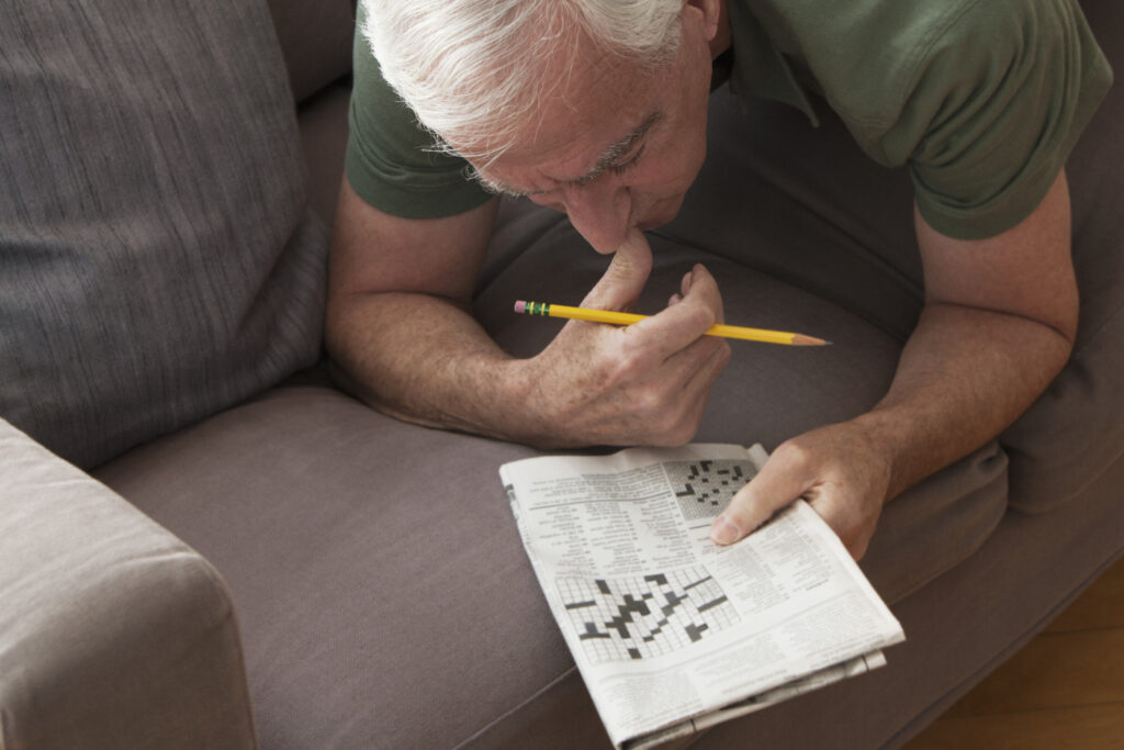 Senior man working on crossword puzzle