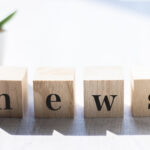 NEWS letters wooden block white background